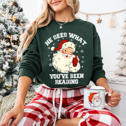 He Sees What You’ve Been Reading Sweatshirt – Funny Santa Christmas Graphic Pullover